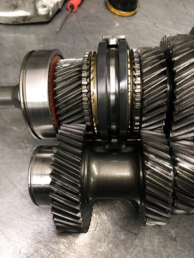 A transmission gearset laid out on the bench for inspection